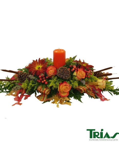 Roses, Rover Mums, Lotus Pods, Pine Cones, Faux Berries, Solidago, Oak Leaves, Fancy Ribbon and a 3x6 pillar candle