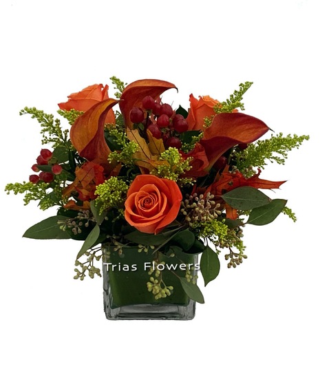 fall flower arrangement in the orange shade of aspen leaves with accents and seeded eucalyptus 